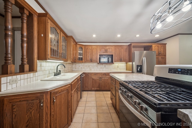 kitchen featuring sink, decorative backsplash, stainless steel appliances, light tile patterned floors, and crown molding