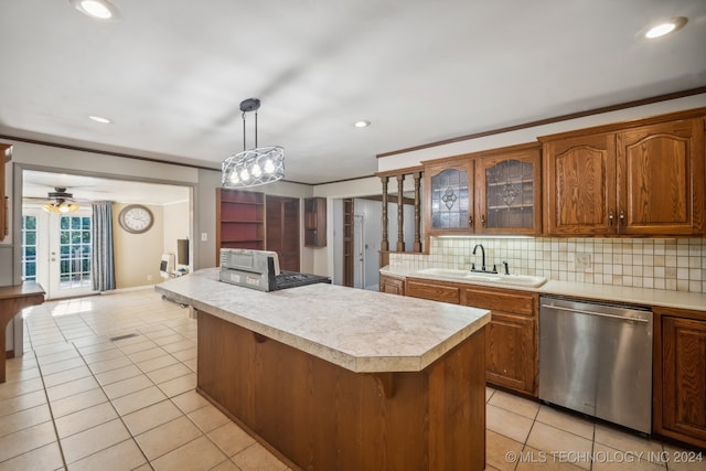 kitchen with backsplash, a kitchen island, dishwasher, decorative light fixtures, and sink