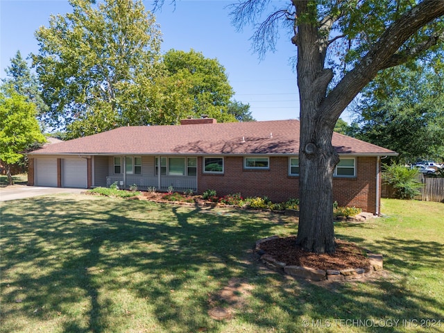 ranch-style house featuring a garage and a front lawn