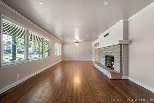 unfurnished living room with a fireplace, ornamental molding, and dark hardwood / wood-style flooring