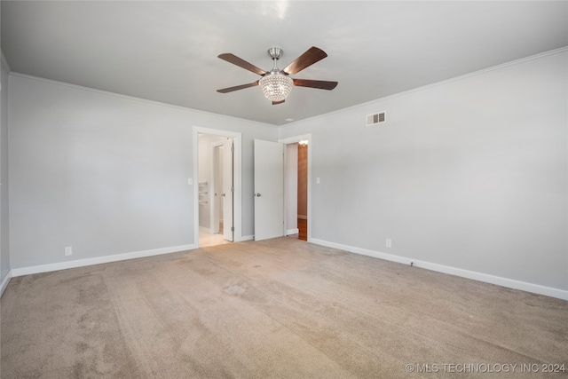 carpeted empty room with crown molding and ceiling fan