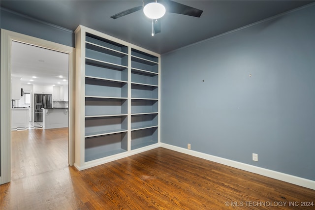 empty room with crown molding, hardwood / wood-style floors, and ceiling fan