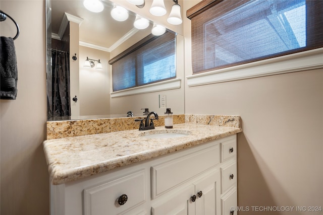 bathroom featuring ornamental molding and vanity