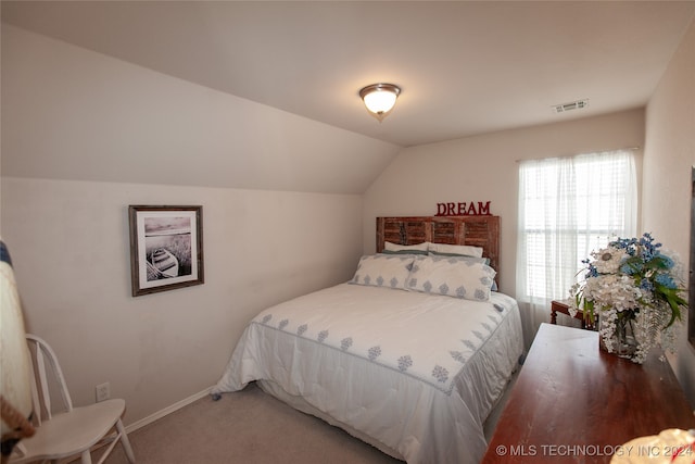 carpeted bedroom featuring vaulted ceiling