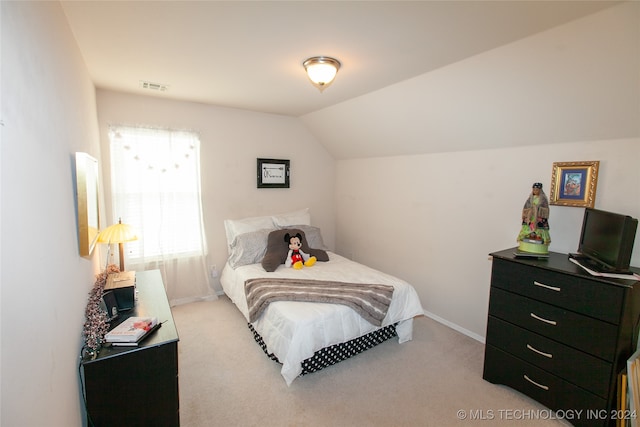 carpeted bedroom with lofted ceiling