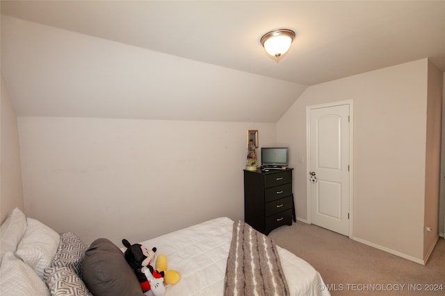 bedroom featuring light carpet and lofted ceiling