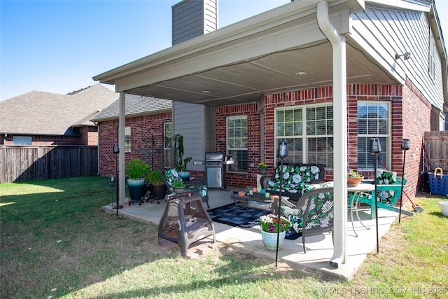 back of house with a patio and a lawn