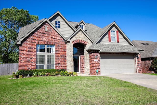 view of front of home with a front yard and a garage