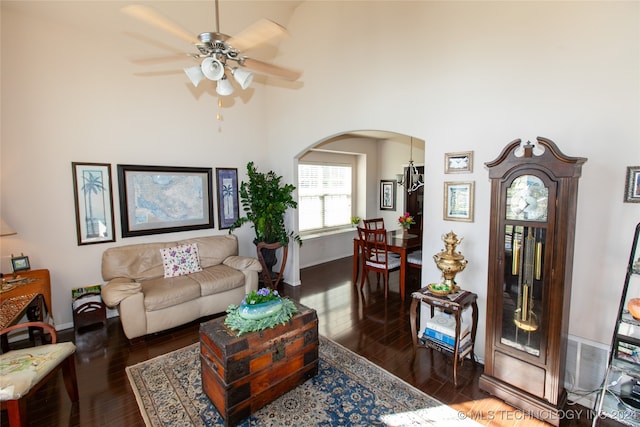 living room with ceiling fan and dark wood-type flooring