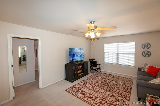 carpeted living room with ceiling fan