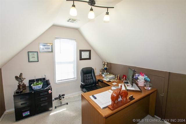 carpeted office space featuring lofted ceiling