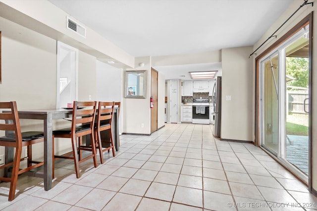 dining area featuring light tile patterned floors