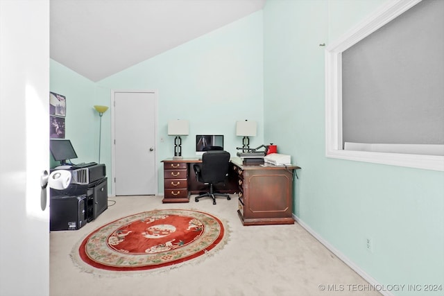 office with lofted ceiling and light carpet