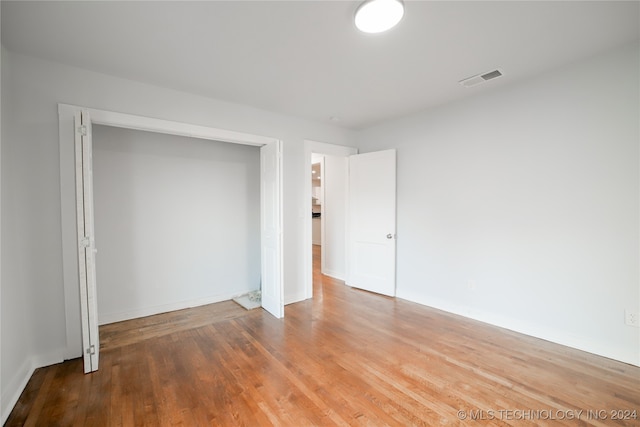 empty room with wood-type flooring