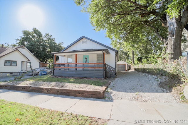 view of front of house featuring an outbuilding, covered porch, and a garage