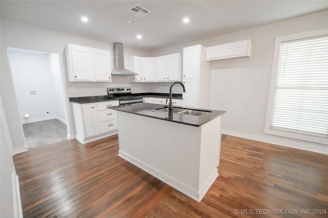 kitchen with stainless steel range with electric cooktop, wall chimney exhaust hood, white cabinetry, and sink