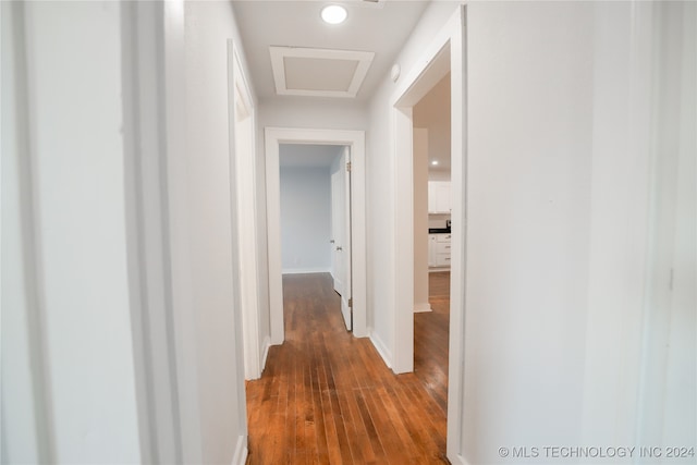 corridor with dark hardwood / wood-style floors