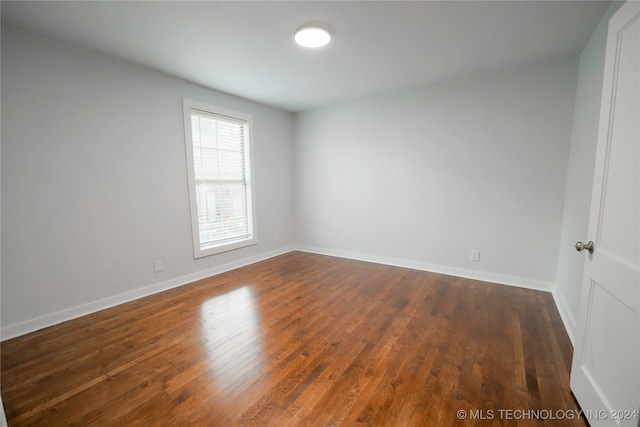 empty room with dark wood-type flooring