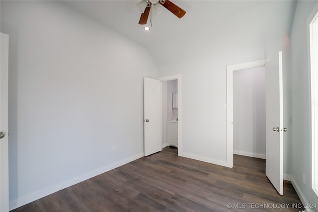 unfurnished bedroom with vaulted ceiling, ceiling fan, and dark wood-type flooring