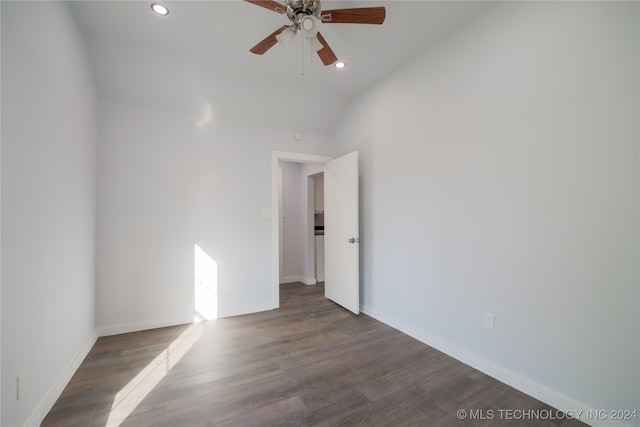 unfurnished room featuring ceiling fan, dark wood-type flooring, and lofted ceiling