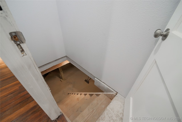 staircase with hardwood / wood-style floors