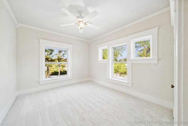 unfurnished room with ceiling fan, crown molding, and light carpet