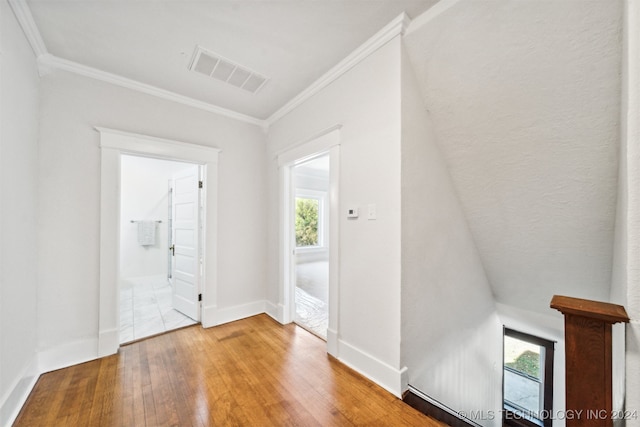 interior space with ornamental molding and wood-type flooring