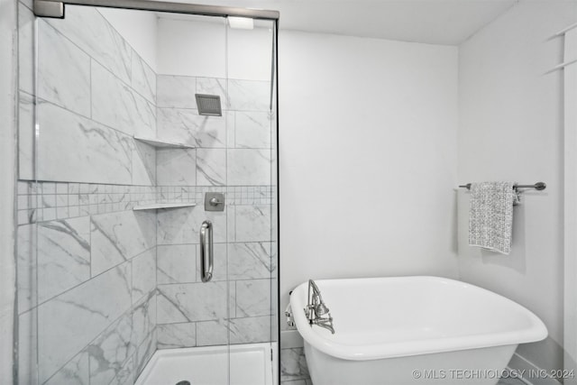 bathroom with separate shower and tub