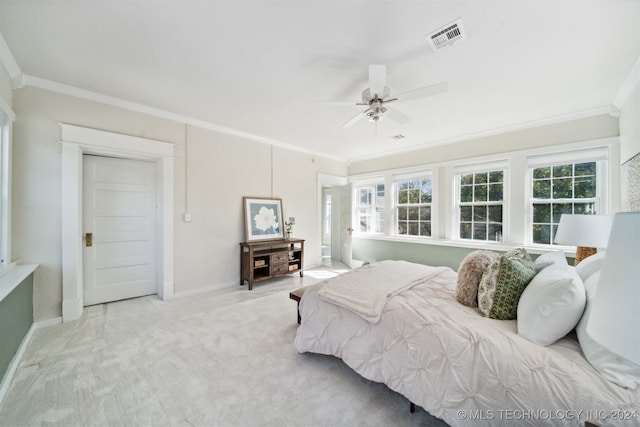 bedroom featuring crown molding, light colored carpet, and ceiling fan