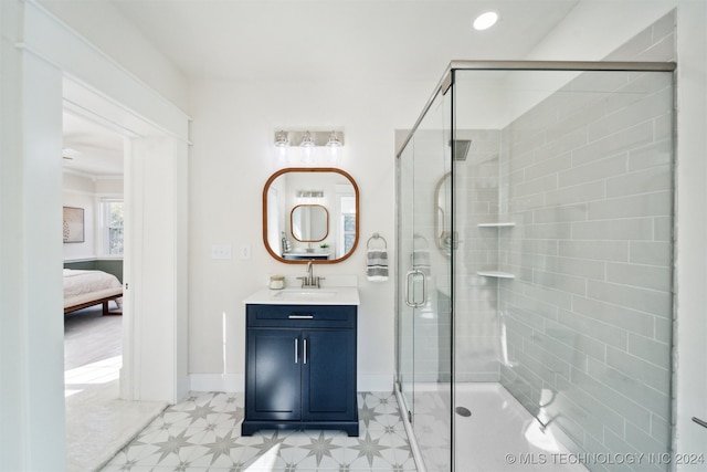 bathroom with a shower with shower door and vanity