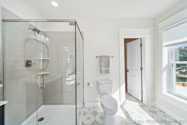 bathroom with toilet and a shower with shower door