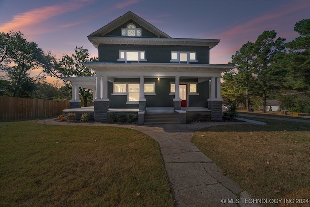 view of front of home featuring a porch and a lawn