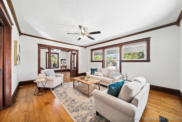 living room featuring ceiling fan, hardwood / wood-style flooring, crown molding, and a wealth of natural light