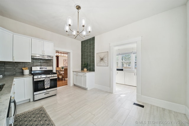 kitchen featuring tasteful backsplash, white cabinets, decorative light fixtures, a chandelier, and stainless steel range