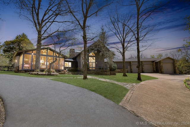 view of front of house with a garage and a yard