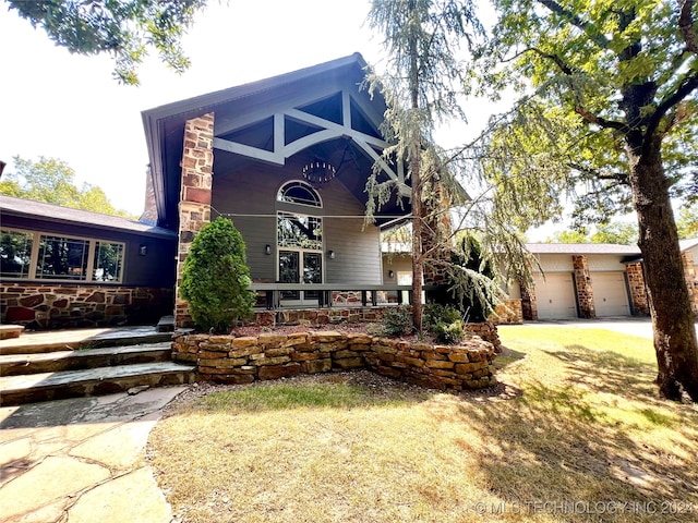 view of front of home with a front lawn and a garage