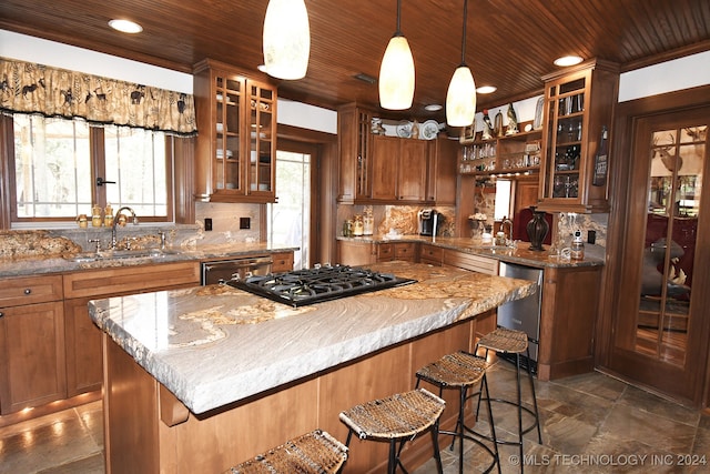 kitchen featuring wood ceiling, backsplash, a breakfast bar area, pendant lighting, and sink