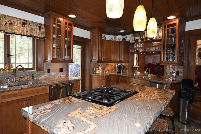 kitchen with backsplash, a kitchen island, pendant lighting, stainless steel dishwasher, and sink