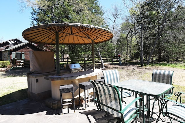 view of patio featuring area for grilling and a grill