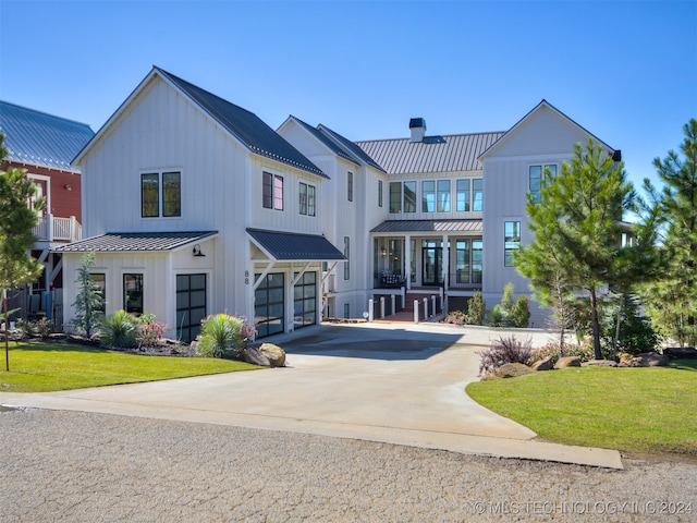 view of front of house with a front yard and a garage