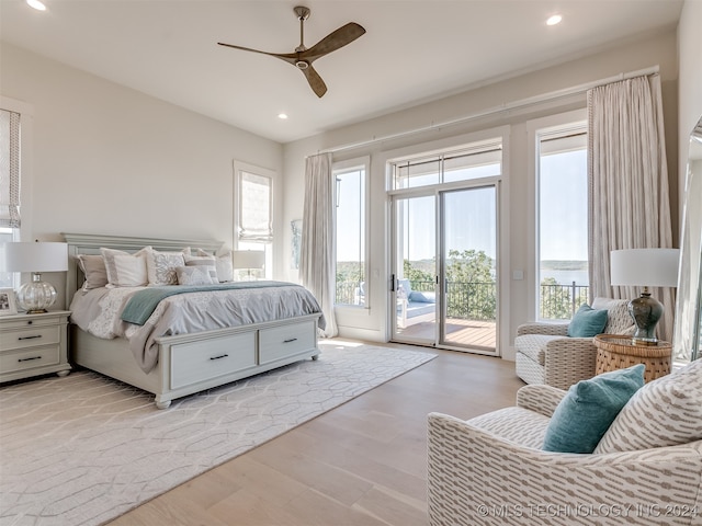 bedroom with light wood-type flooring, multiple windows, access to outside, and ceiling fan