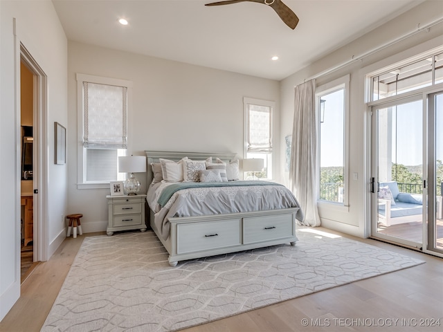 bedroom featuring ceiling fan, multiple windows, light wood-type flooring, and access to exterior