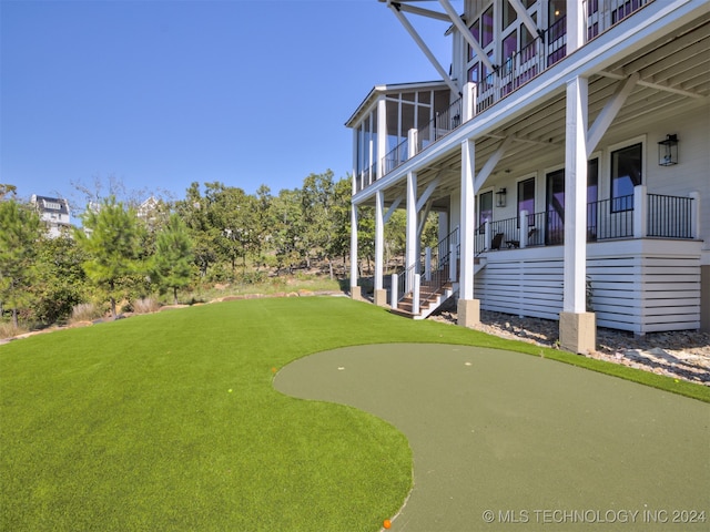 view of yard with a balcony