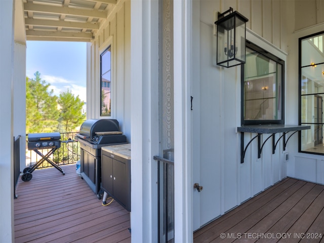 wooden terrace featuring a grill