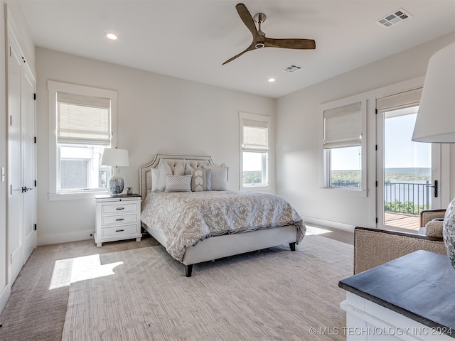 bedroom with light carpet, access to exterior, and ceiling fan