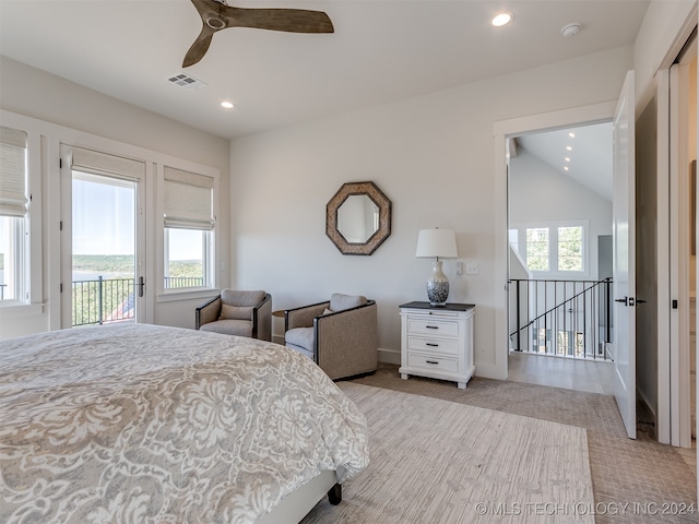 bedroom with multiple windows, ceiling fan, access to exterior, and vaulted ceiling