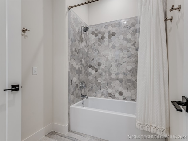 bathroom with shower / bath combo with shower curtain