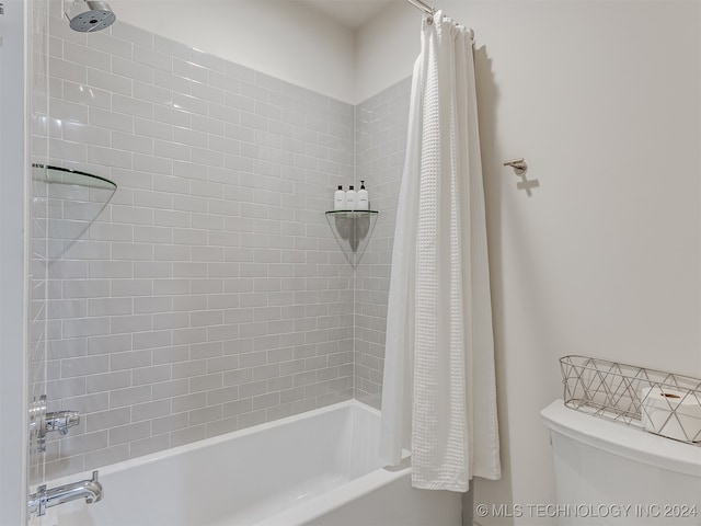 bathroom with toilet and shower / bath combo with shower curtain