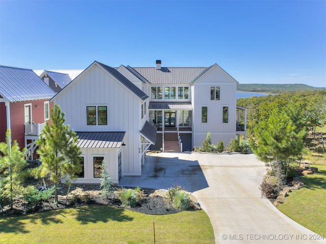 view of front of home with a balcony and a front yard