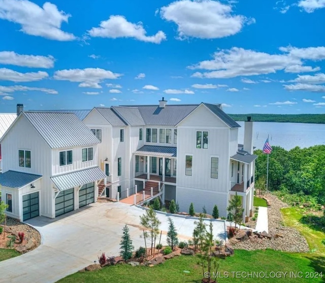 view of front of property featuring a water view and a garage